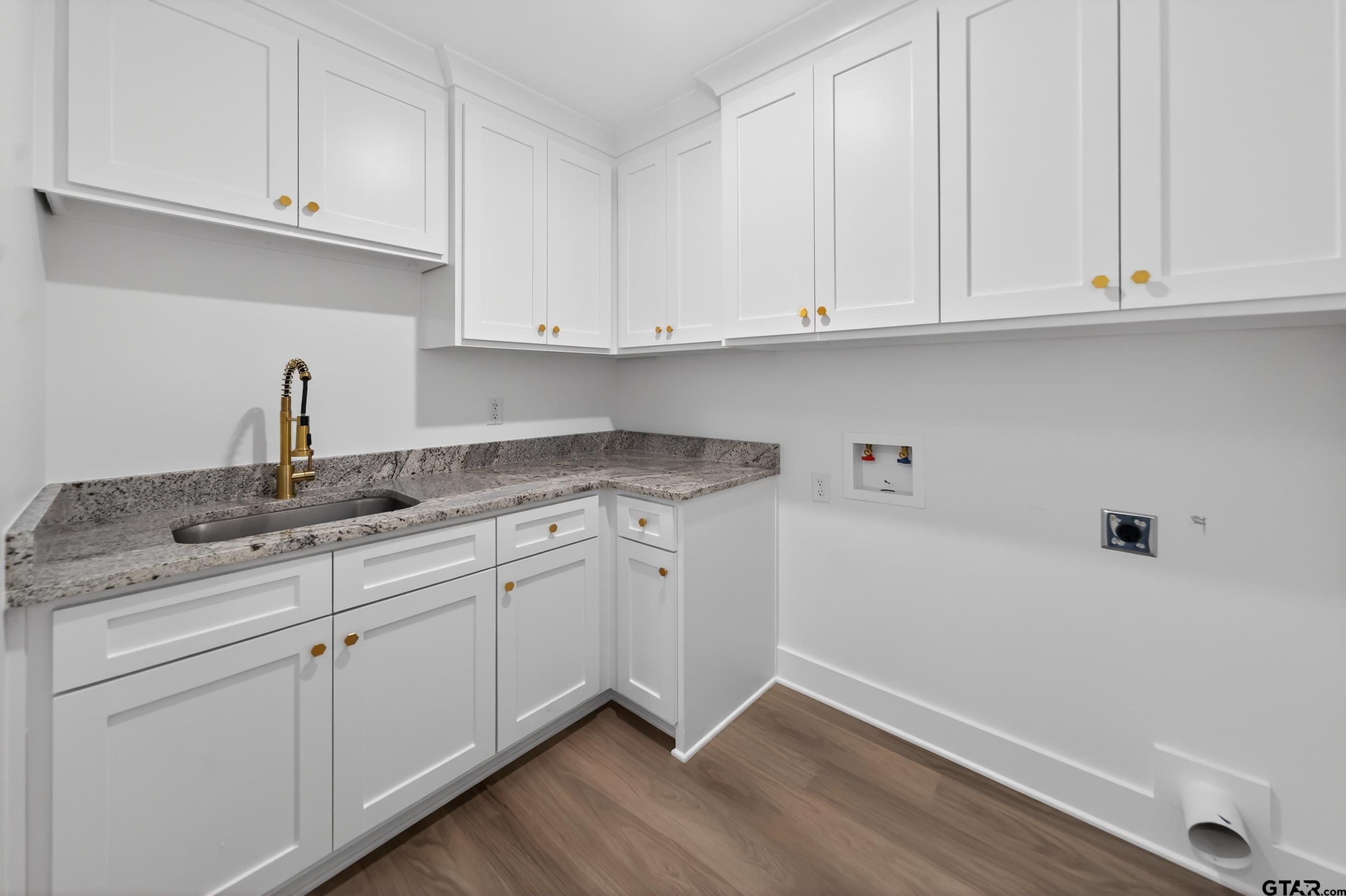 329 Wiley Drive Bullard, TX 75757 - Photo 17 of 31 a kitchen with granite countertop white cabinets and a sink