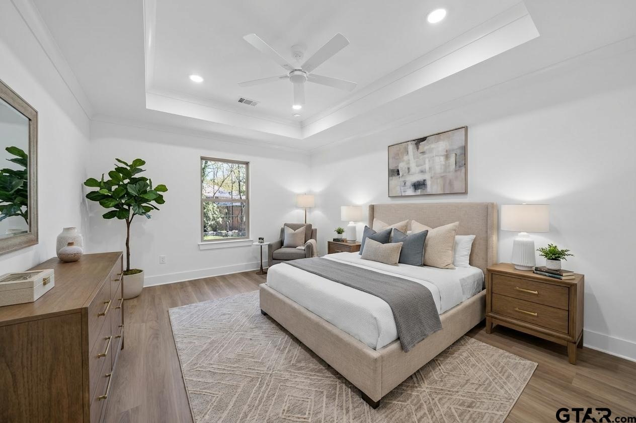 329 Wiley Drive Bullard, TX 75757 - Photo 21 of 31 a spacious bedroom with a large bed and a potted plant