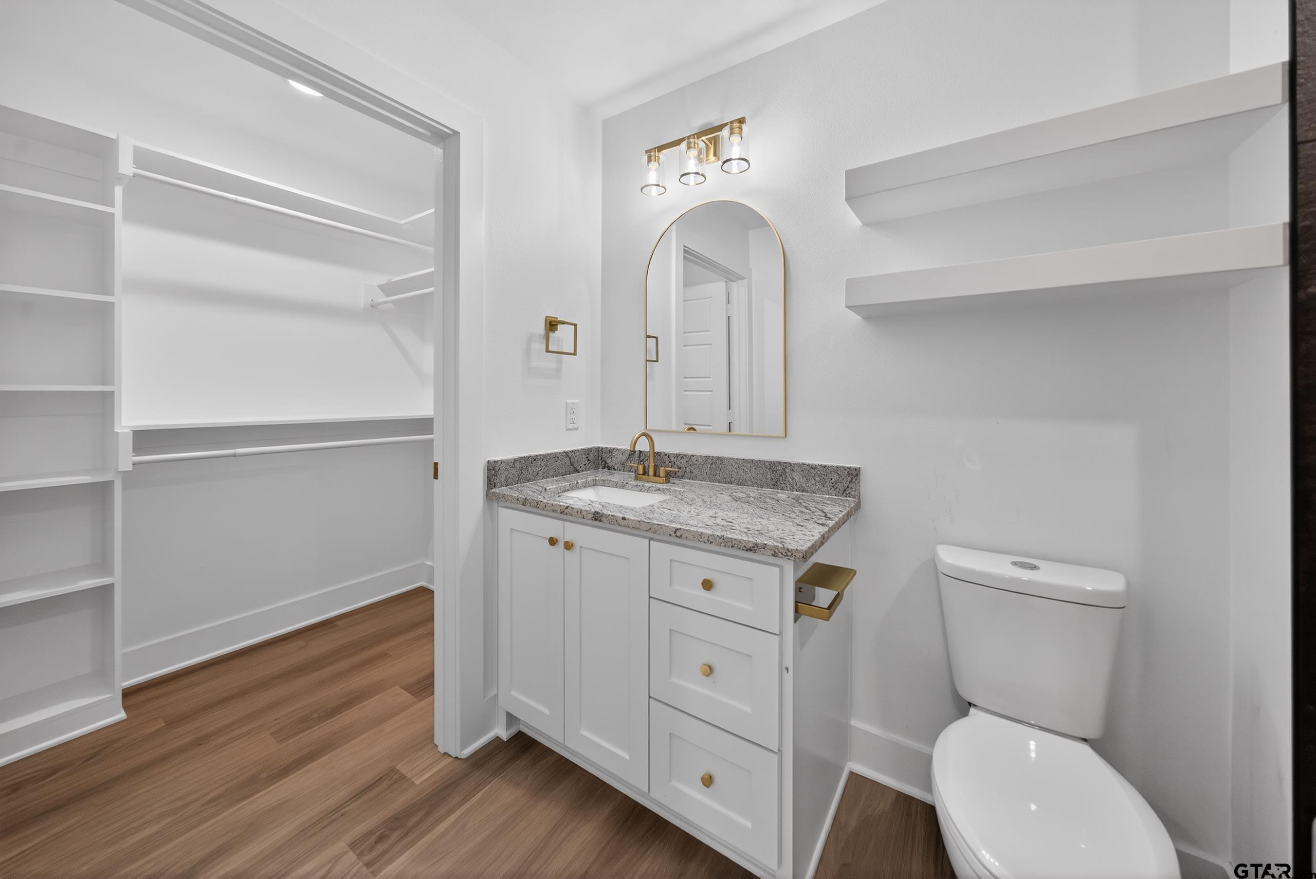 329 Wiley Drive Bullard, TX 75757 - Photo 24 of 31 a bathroom with a granite countertop toilet sink and mirror