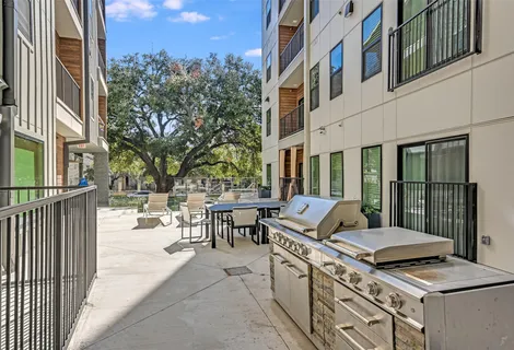 a view of a patio with couches table and chairs and potted plants