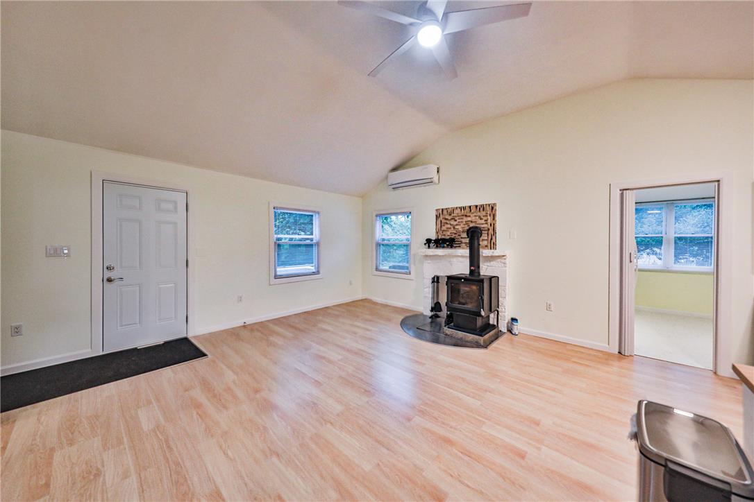 5599 Minks Pond Road Bushkill, PA 18324 - Photo 5 of 64 A welcoming interior with warm wood floors and a charming fireplace feature.