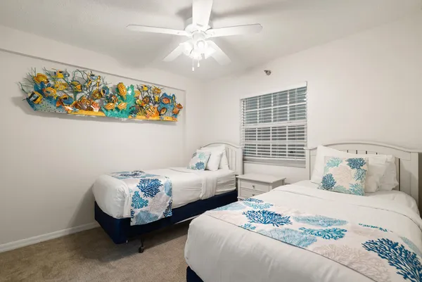 a bedroom with two beds and a window