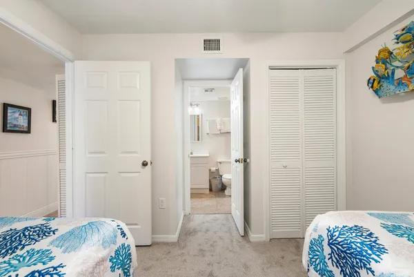 a bedroom with a bed and hallway