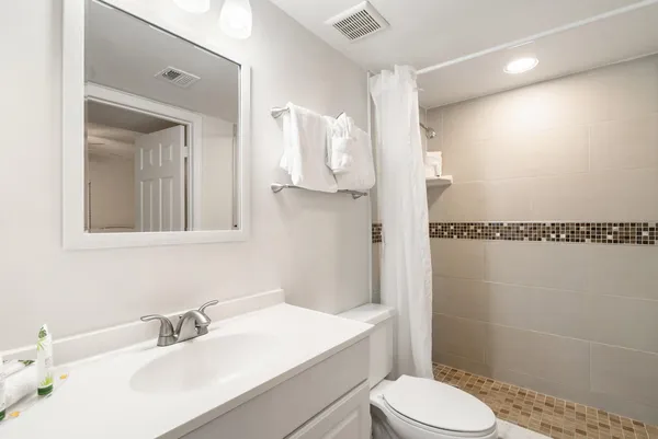 a bathroom with a sink vanity and mirror
