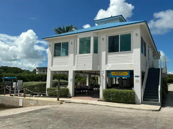 an outdoor space with lots of furniture and glass windows