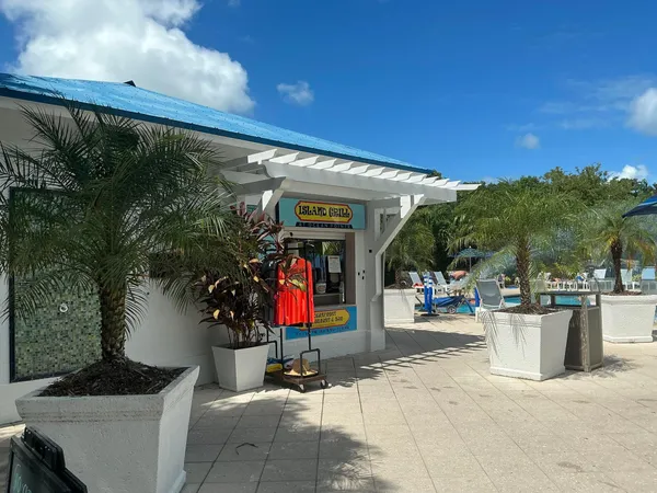 a dining room with furniture and a floor to ceiling window