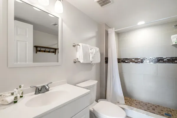a bathroom with a sink toilet and shower