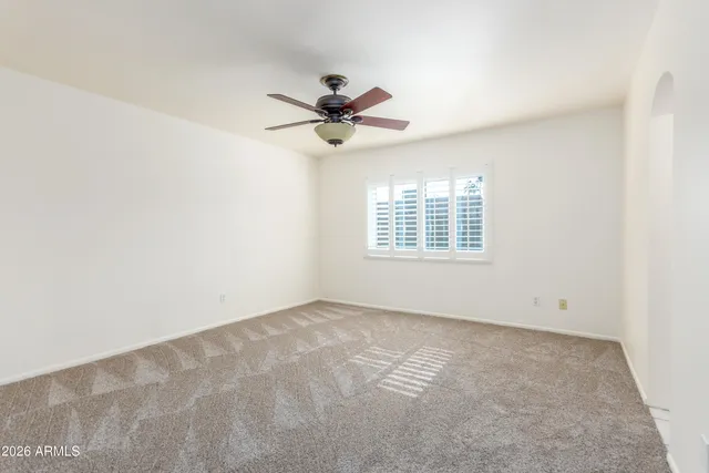 a view of a livingroom with a ceiling fan and entryway