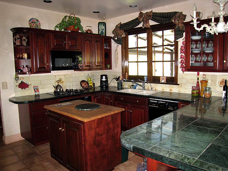 466 Toro Canyon Road Carpinteria, CA 93013 - Photo 10 of 26 a kitchen with granite countertop a sink stove and cabinets