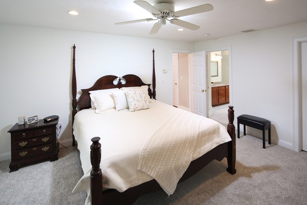 375 Webster Street Hanover, MA 02339 - Photo 13 of 24 a bedroom with a bed and a chandelier