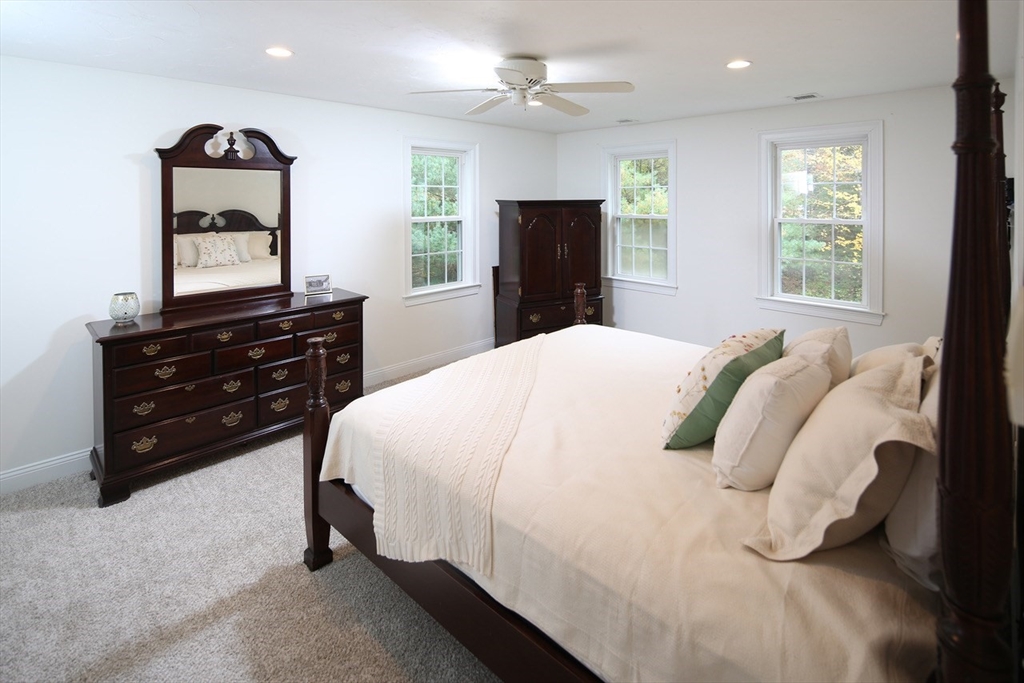 375 Webster Street Hanover, MA 02339 - Photo 14 of 24 a bedroom with a bed and a dresser