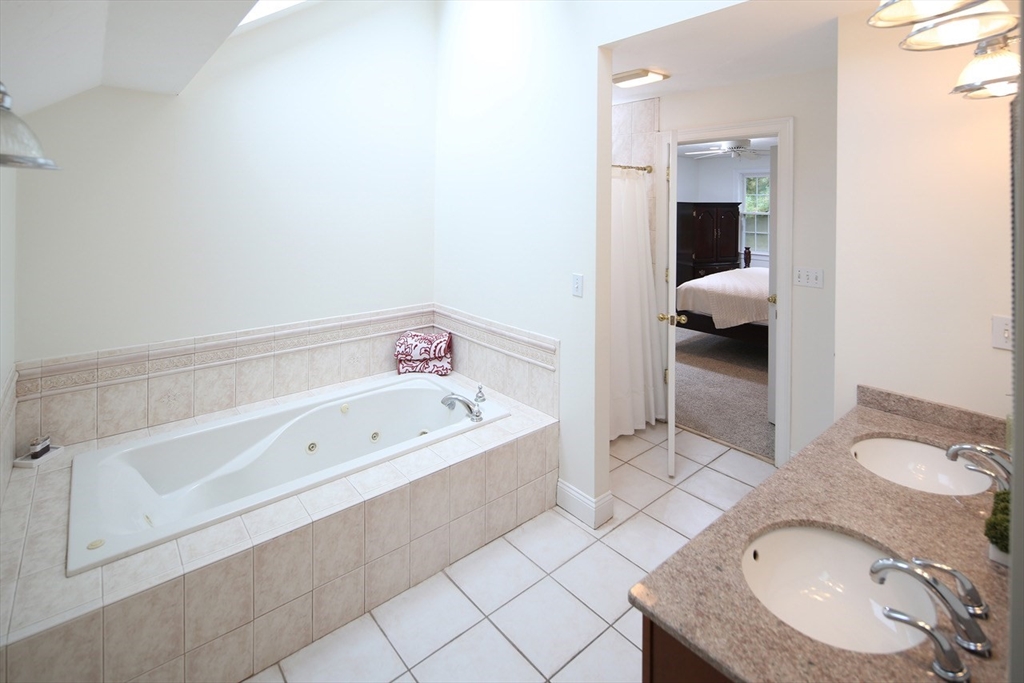375 Webster Street Hanover, MA 02339 - Photo 17 of 24 a en suite bathroom with a granite countertop tub and a sink
