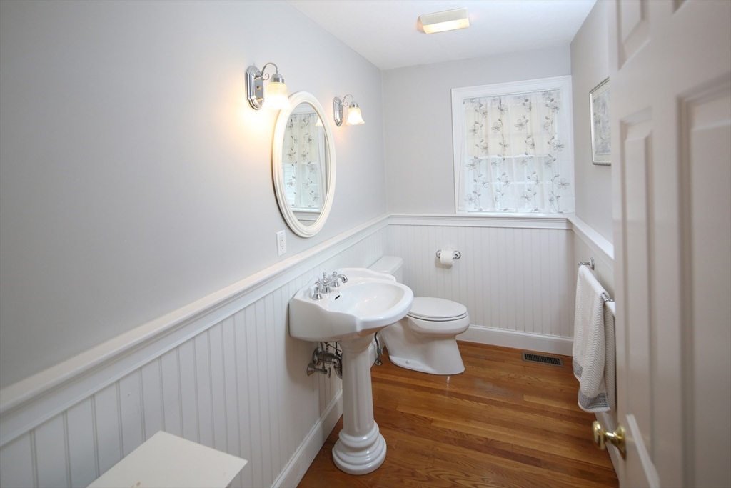 375 Webster Street Hanover, MA 02339 - Photo 18 of 24 a bathroom with a toilet a sink and a mirror