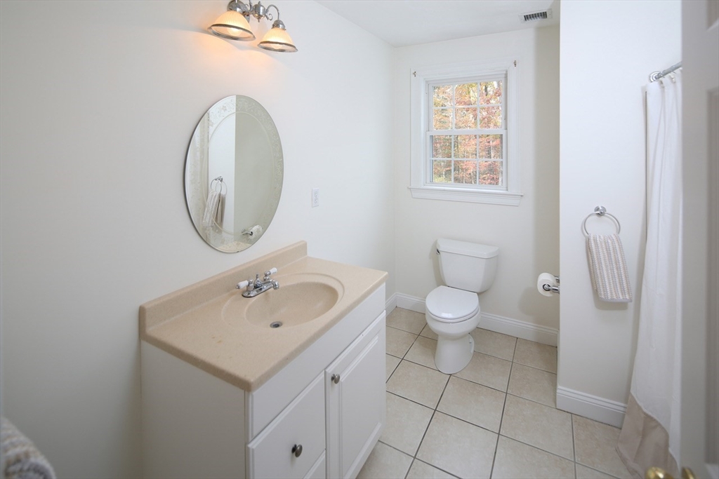 375 Webster Street Hanover, MA 02339 - Photo 19 of 24 a bathroom with a toilet a sink and a mirror