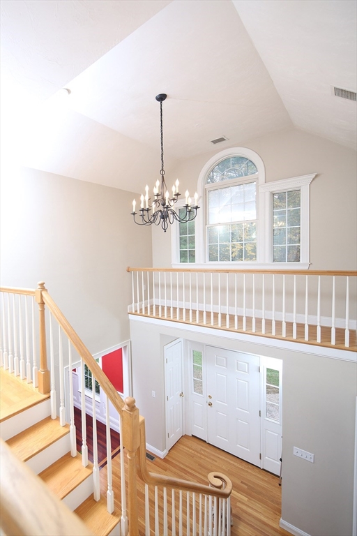 375 Webster Street Hanover, MA 02339 - Photo 3 of 24 a view of a livingroom with wooden floor and chandelier