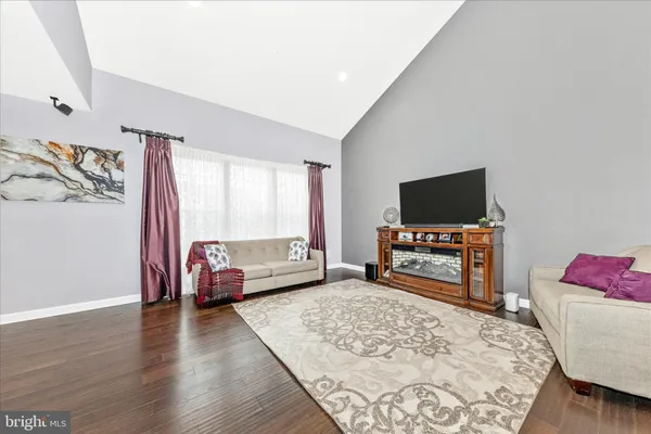 a bedroom with furniture and a flat screen tv