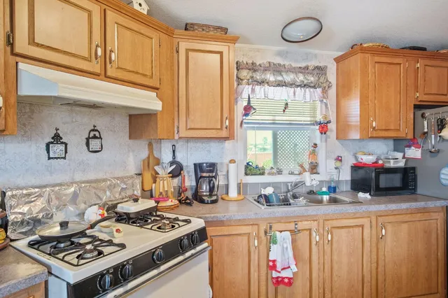 a kitchen that has a lot of cabinets in it and a window
