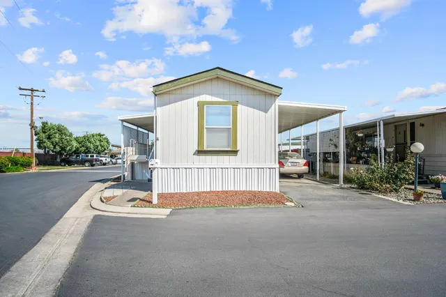 a view of a house with entertaining space and a street