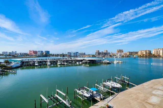 a roof deck with table and chairs and potted plants