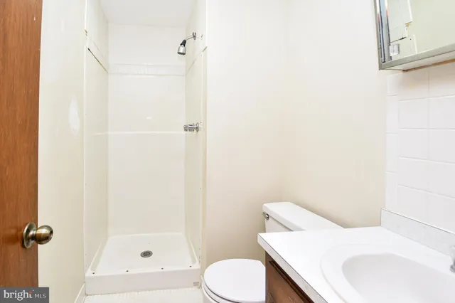 a bathroom with a sink a toilet and shower curtain