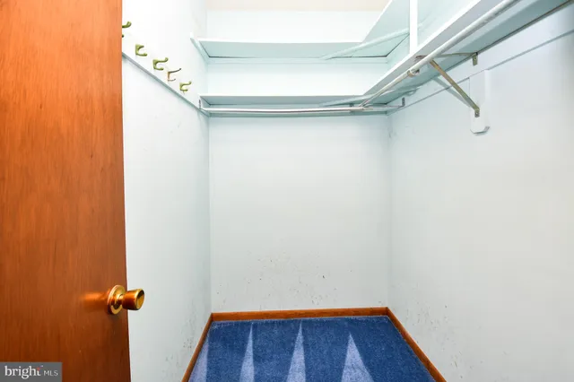 a bathroom with a granite countertop sink a toilet and a mirror