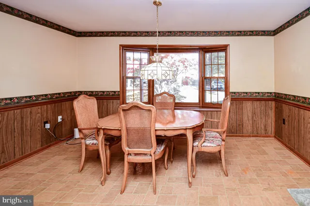 a dining room with furniture and window