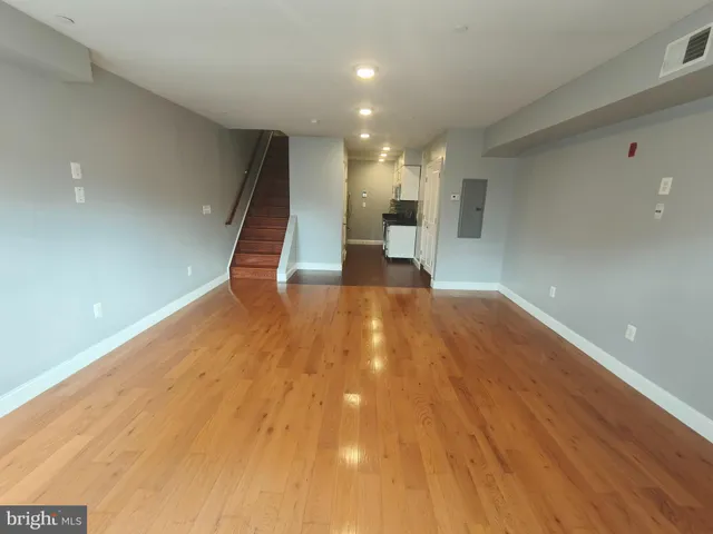 a view of a hallway with wooden floor