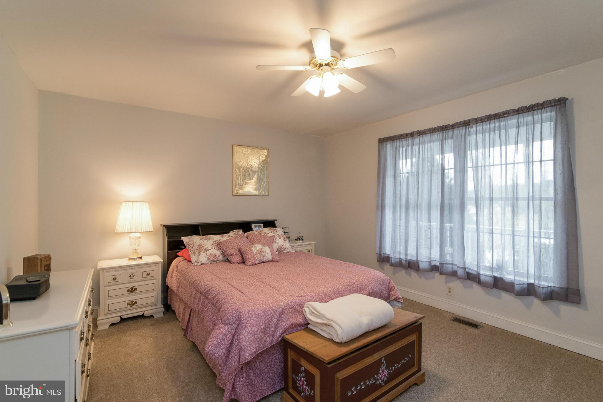 2501 Braddock Road Mount Airy, MD 21771 - Photo 26 of 30 a bedroom with a bed and a chandelier
