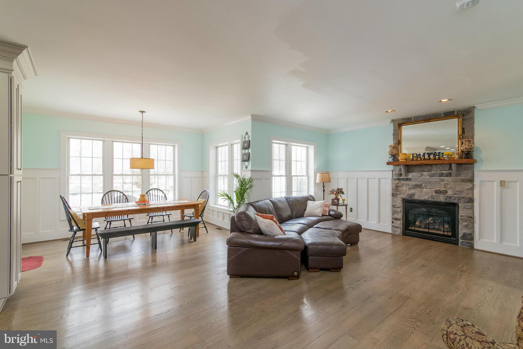 2501 Braddock Road Mount Airy, MD 21771 - Photo 6 of 30 a living room with furniture a fireplace and wooden floor