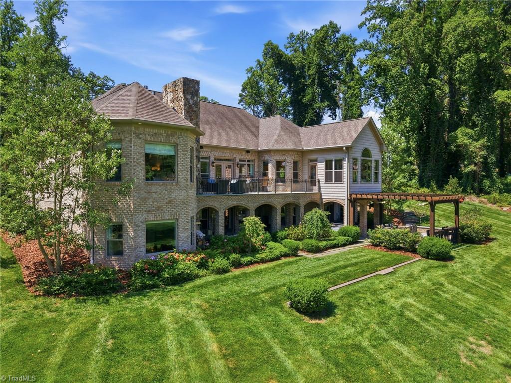 5306 Rockingham Road East Greensboro, NC 27407 - Photo 41 of 47 The view of the home from the golf course is just as stunning as the front.