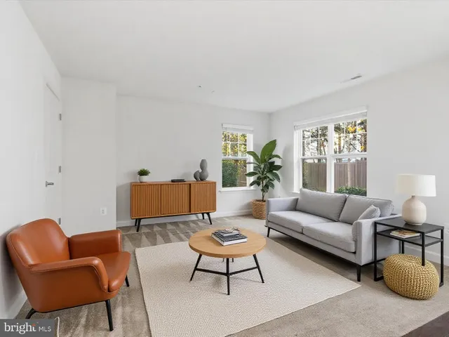 a living room with furniture a rug and a large window