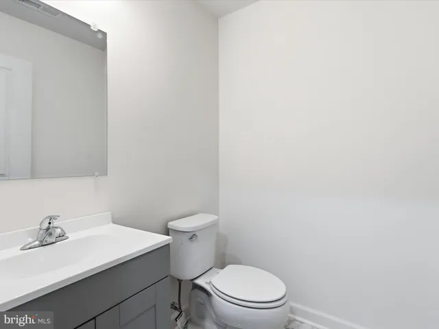 a white toilet sitting next to a bathroom sink