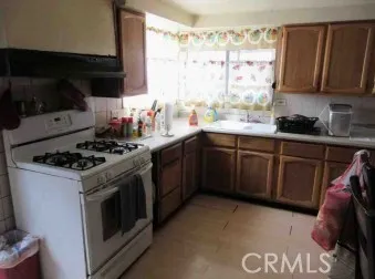 a kitchen with a stove a sink and a microwave