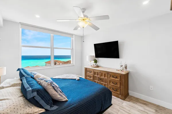 a bedroom with a bed and a flat screen tv