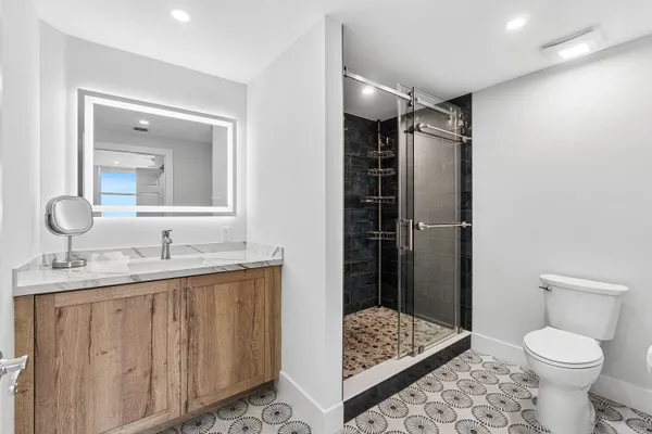 a bathroom with a sink toilet and shower