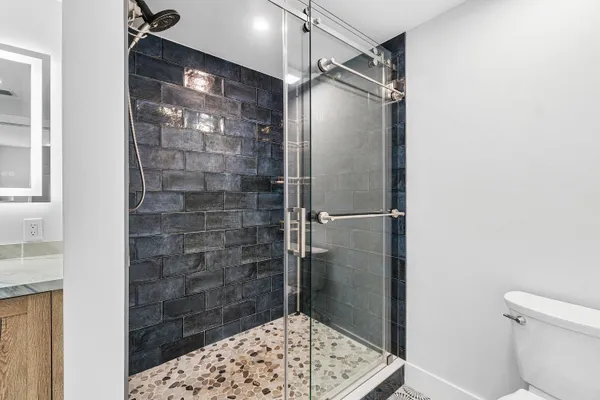 a bathroom with a glass shower door