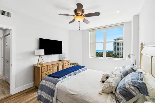 a bedroom with a bed tv and a window