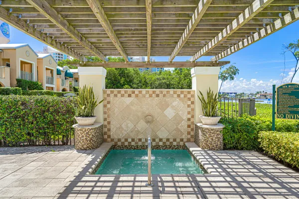 a living room with furniture a chandelier and a large window
