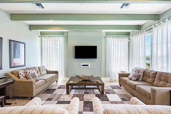 a room with furniture pool table and windows