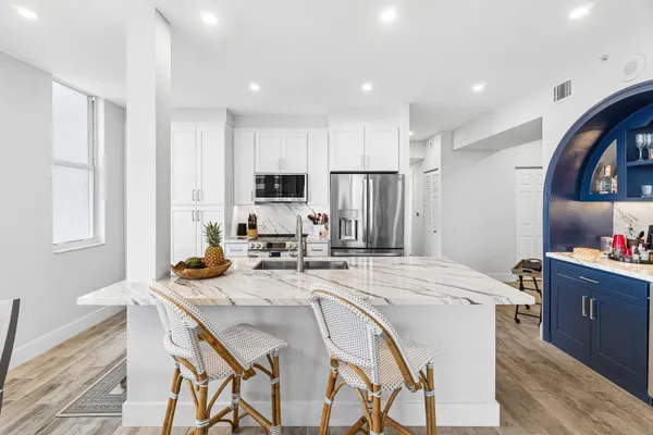 a kitchen with a stove a sink a refrigerator and cabinets