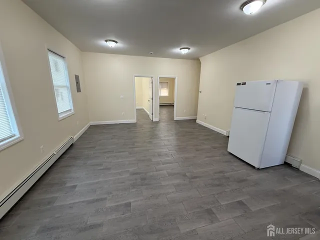 a view of a livingroom with wooden floor and a window