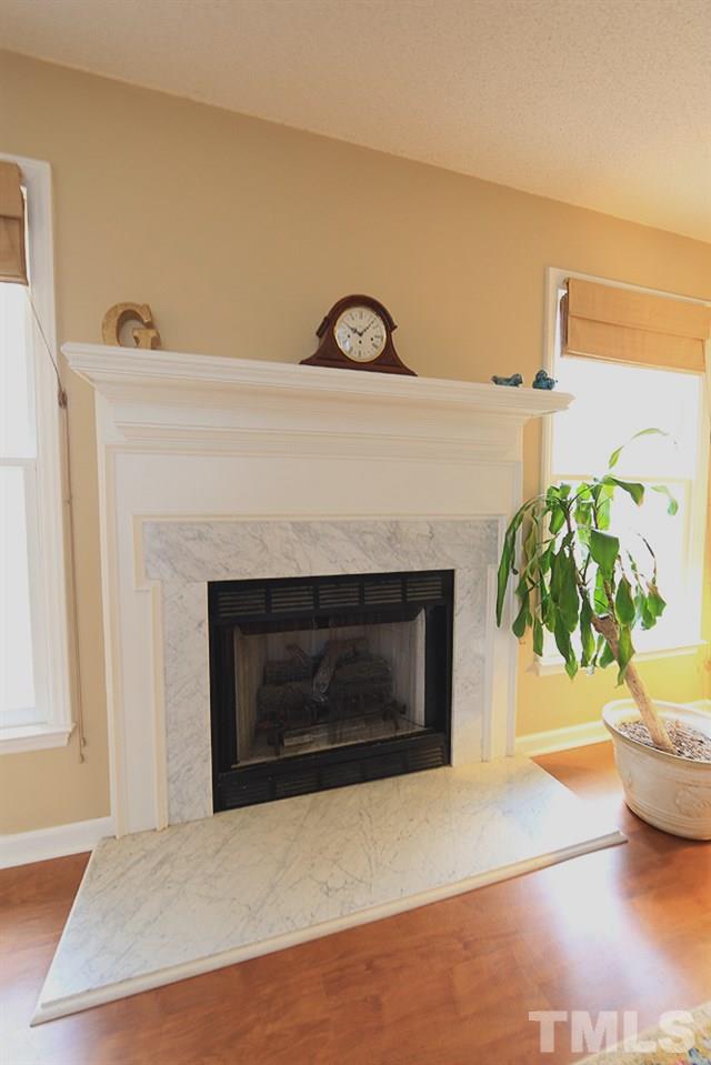 204 Lassiter Farm Road Raleigh, NC 27603 - Photo 11 of 30 A closeup of the fireplace with marble surround.