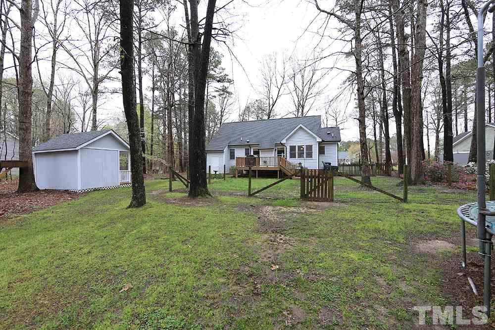204 Lassiter Farm Road Raleigh, NC 27603 - Photo 26 of 30 A view from the backyard looking toward the home. There is a workshop with electricity and a playhouse (both convey as is).