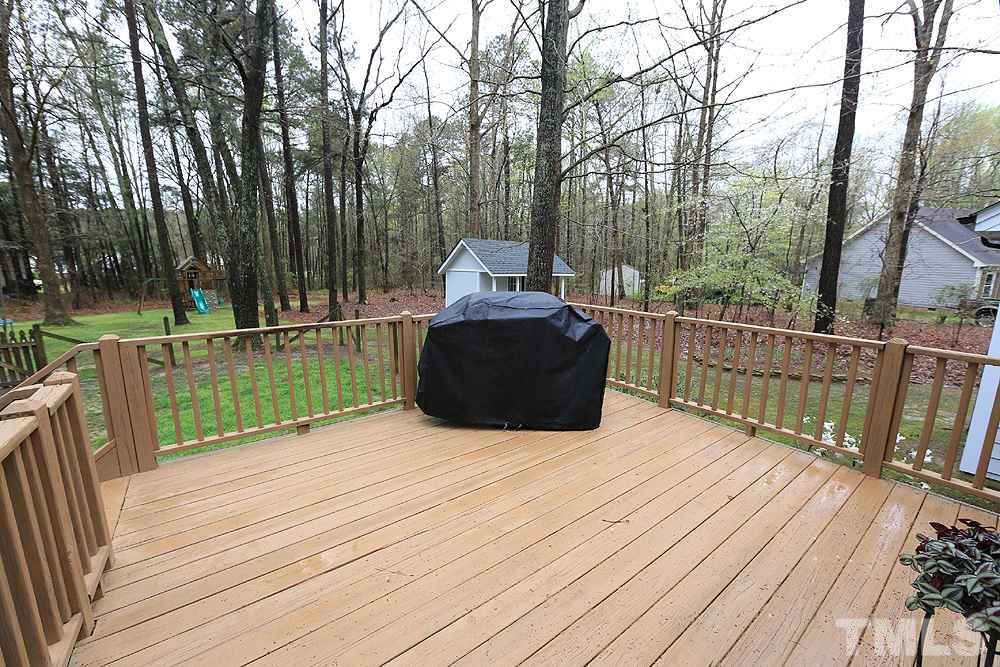 204 Lassiter Farm Road Raleigh, NC 27603 - Photo 27 of 30 Relax and enjoy the privacy in your backyard from the deck.