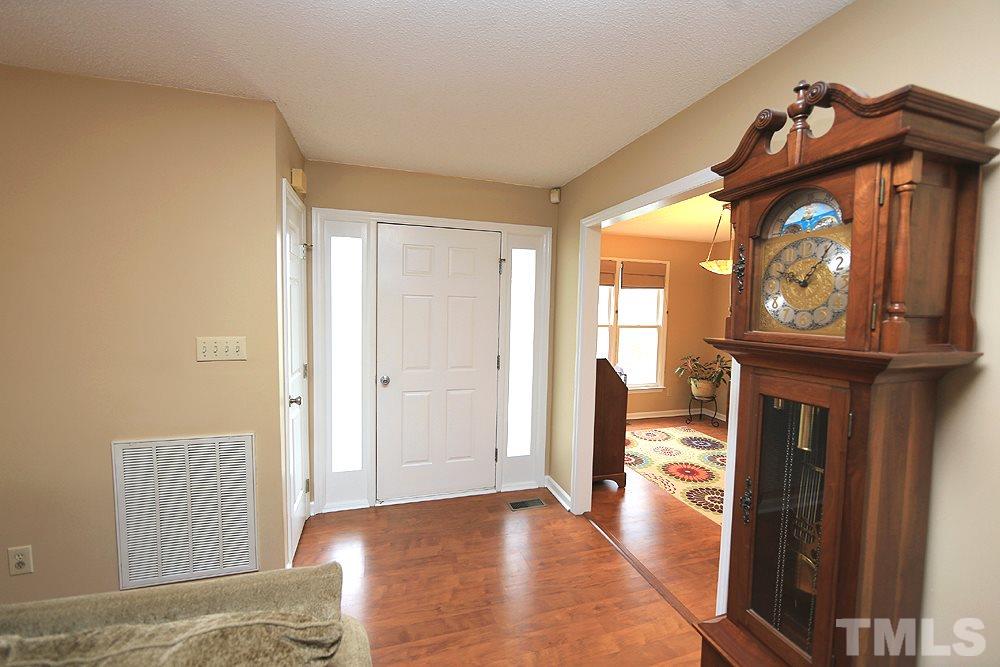 204 Lassiter Farm Road Raleigh, NC 27603 - Photo 5 of 30 The front door has sidelights and there is a storm door.
