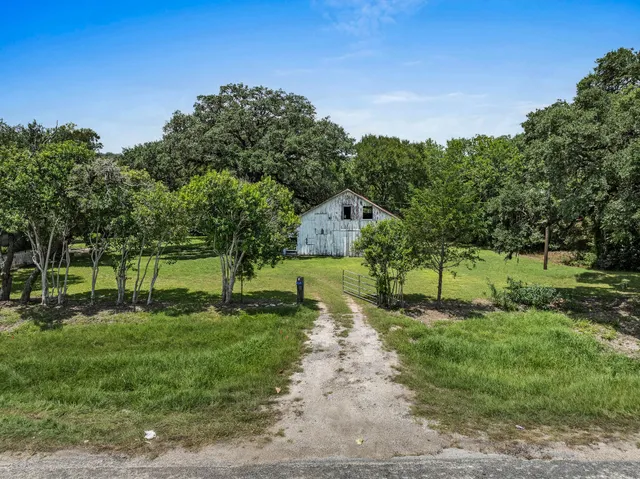 a view of a park with a house in the background