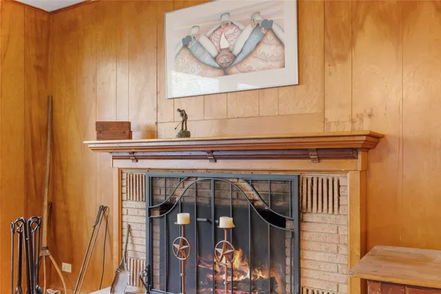 a dining room with furniture and a floor to ceiling window