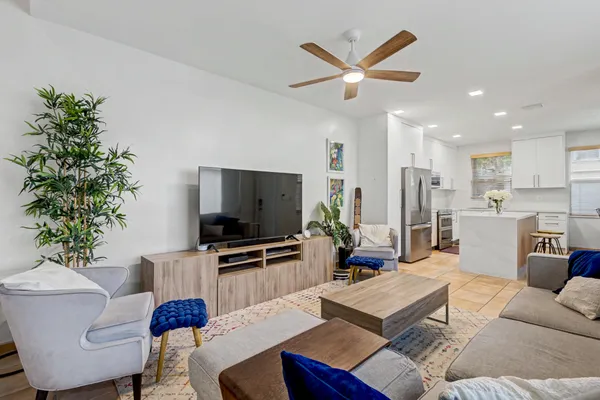 a living room with furniture a window and a flat screen tv