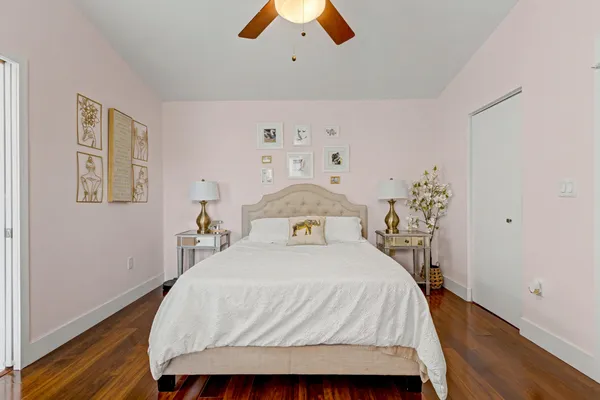 a bedroom with a bed and a chandelier