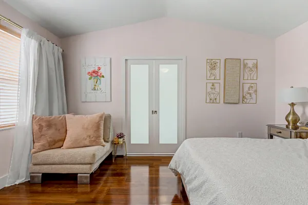 a bathroom with a granite countertop sink vanity mirror and toilet